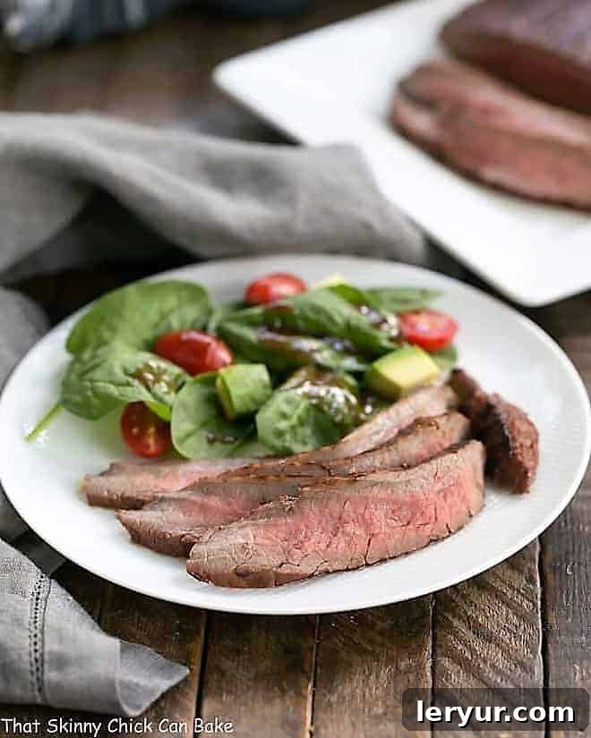 Red Wine, Soy, Balsamic Marinated Flank Steak on a white dinner plate