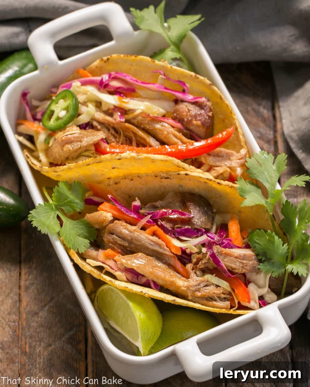 Slow Cooker Asian Pork Tacos with Cabbage Slaw in a white casserole dish.