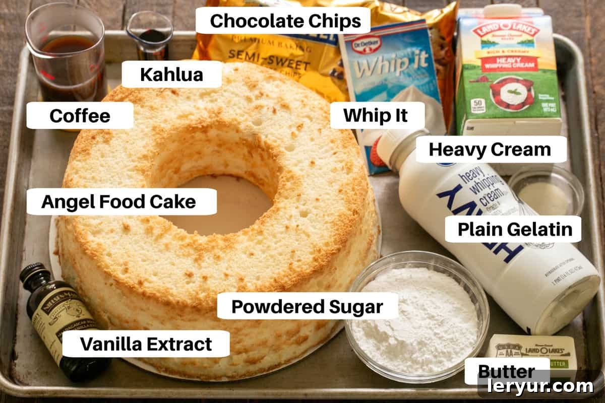 Organized ingredients for mousse-filled angel food cake on a sheet pan, clearly labeled for easy preparation, including angel food cake, heavy cream, chocolate, coffee, Kahlua, butter, gelatin, powdered sugar, Whip-It, and vanilla extract.
