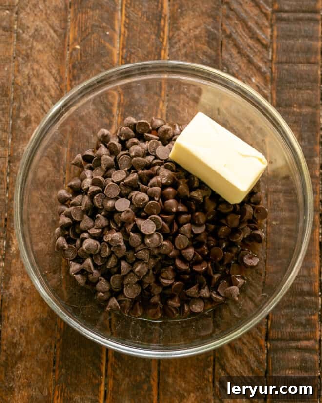 Chocolate chips, coffee, Kahlua, and butter melting in a bowl, ingredients for the chocolate mousse.