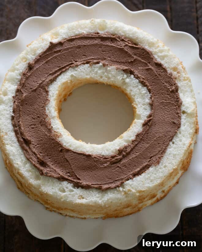 Overhead view of the angel food cake trench filled generously with smooth chocolate mousse.