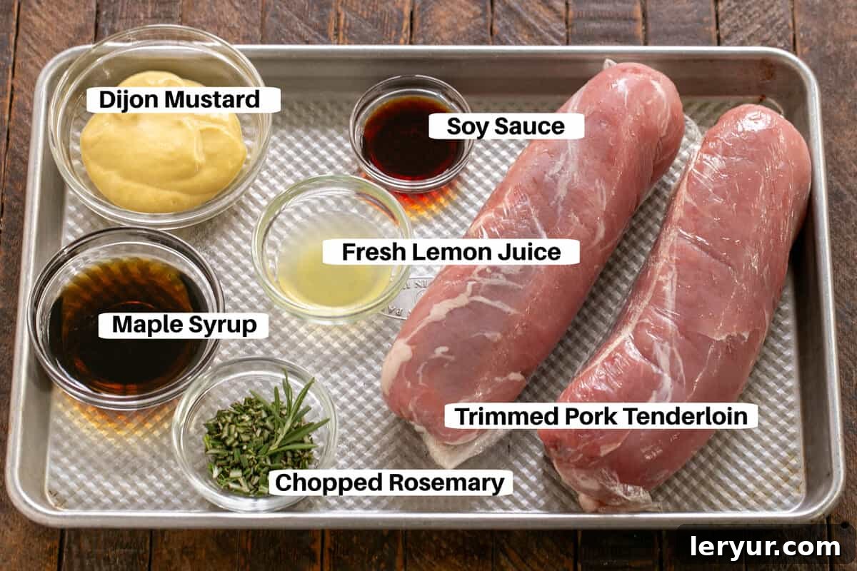 Grilled Maple-Glazed Pork Tenderloin 3 All the essential ingredients for Maple Grilled Pork Tenderloin are neatly arranged on a metal sheet pan, clearly labeled for easy identification.
