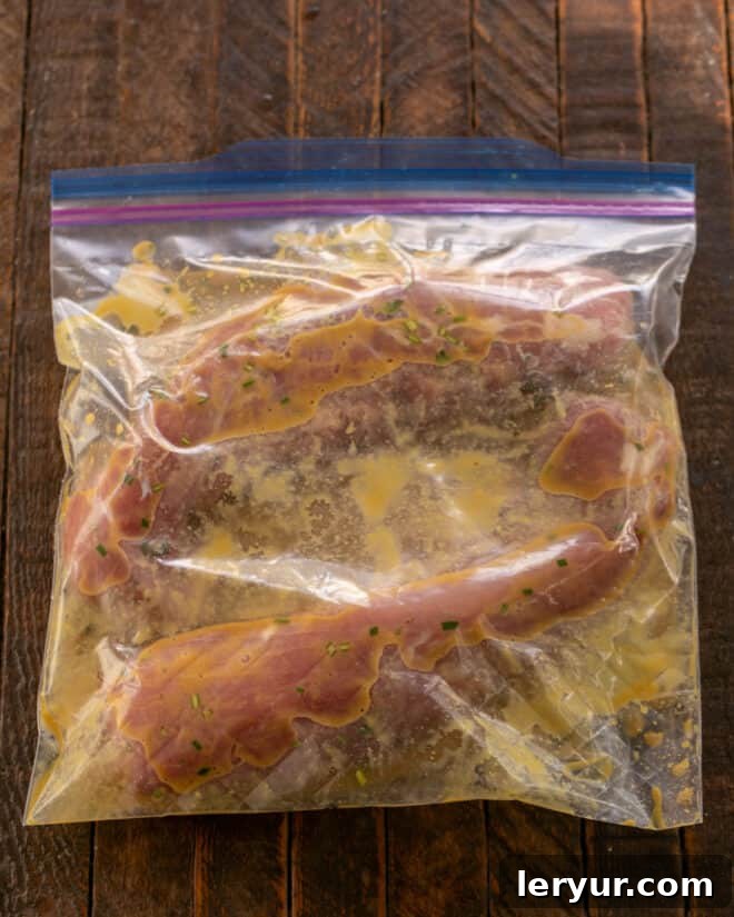 Grilled Maple-Glazed Pork Tenderloin 5 Pork tenderloins are placed inside a Ziploc bag, ready to be submerged in the freshly mixed maple and mustard marinade before grilling.