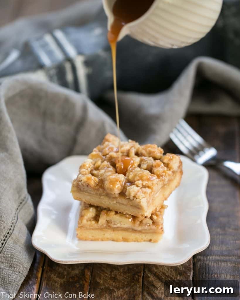 A stream of rich caramel pouring over a stack of golden Caramel Apple Pie Bars, highlighting their luscious topping.