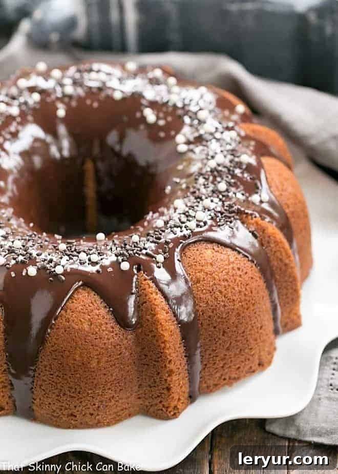 Tunnel of Fudge Cake on a white serving plate, showcasing its elegant form.