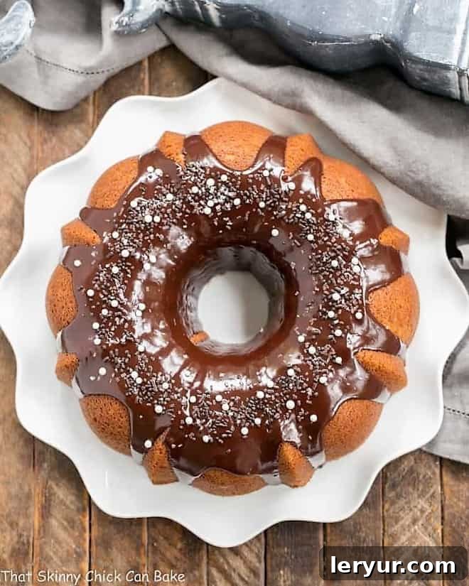 Overhead view of Tunnel of Fudge Cake on a white ripple edge plate, showcasing its intricate design.