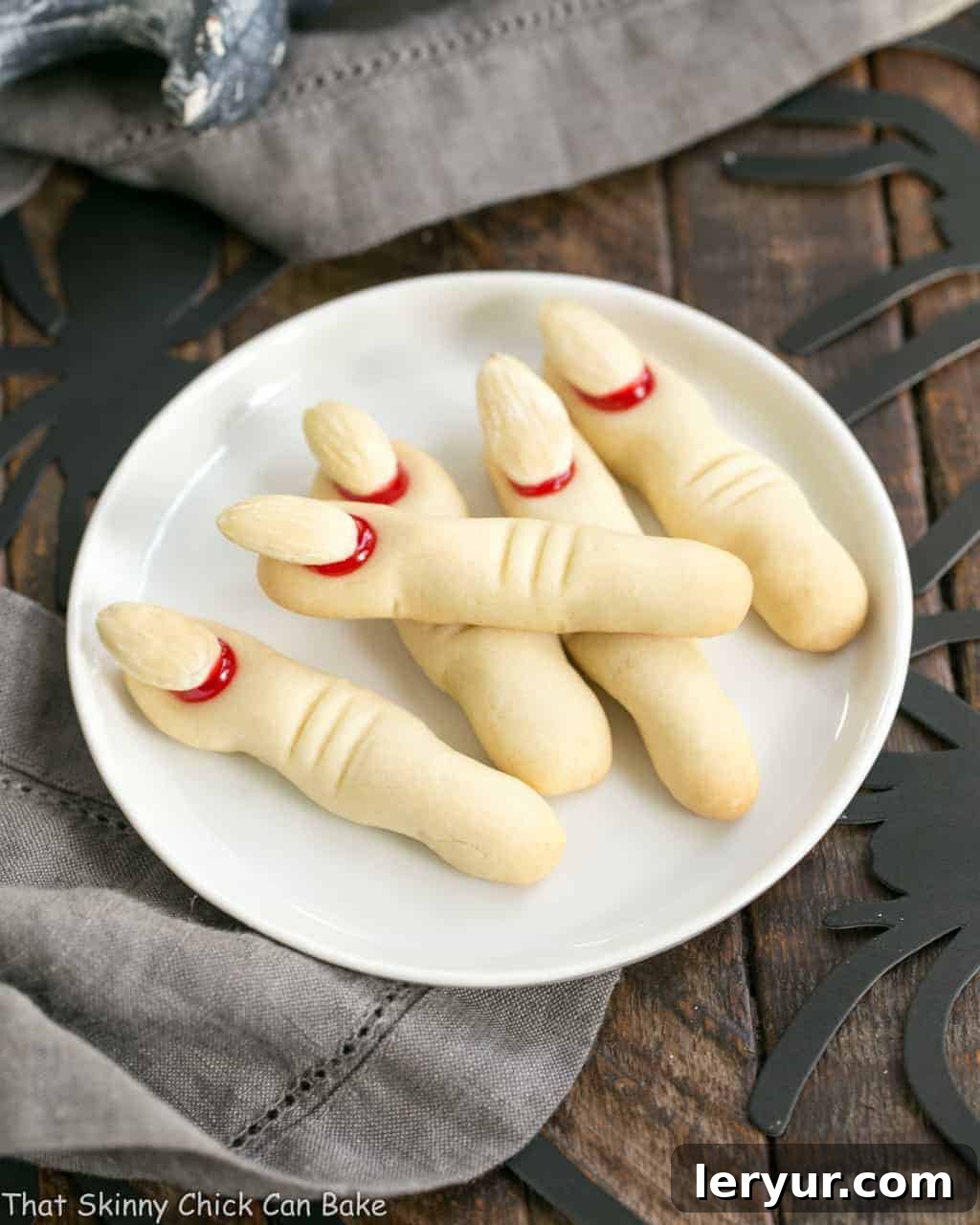 Gnarly Witches Fingers Cookies arranged on a round white ceramic plate, perfect for Halloween.