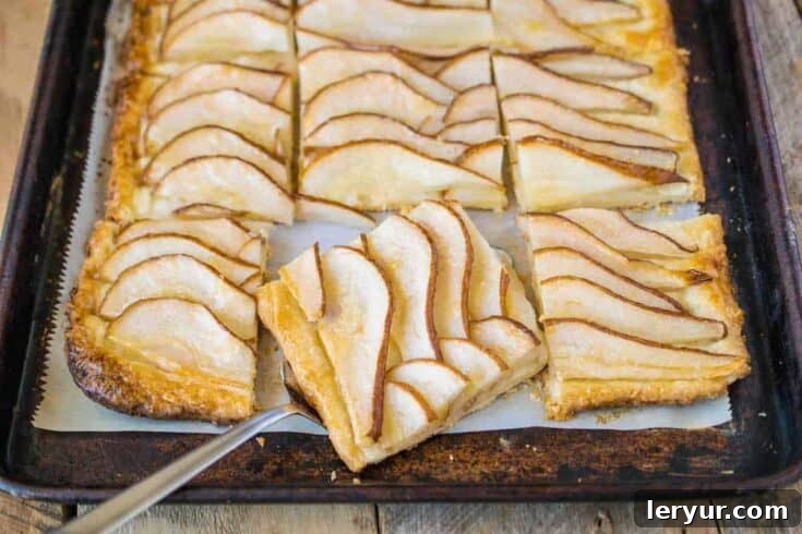 An Easy Pear Tart with fanned sliced pears on a flaky pastry, brushed with a glossy preserve.