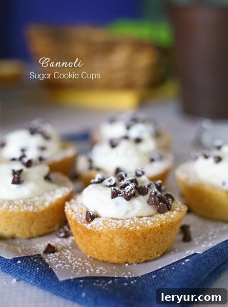 Cannoli Sugar Cookie Cups, filled with creamy cannoli filling and topped with chocolate chips.