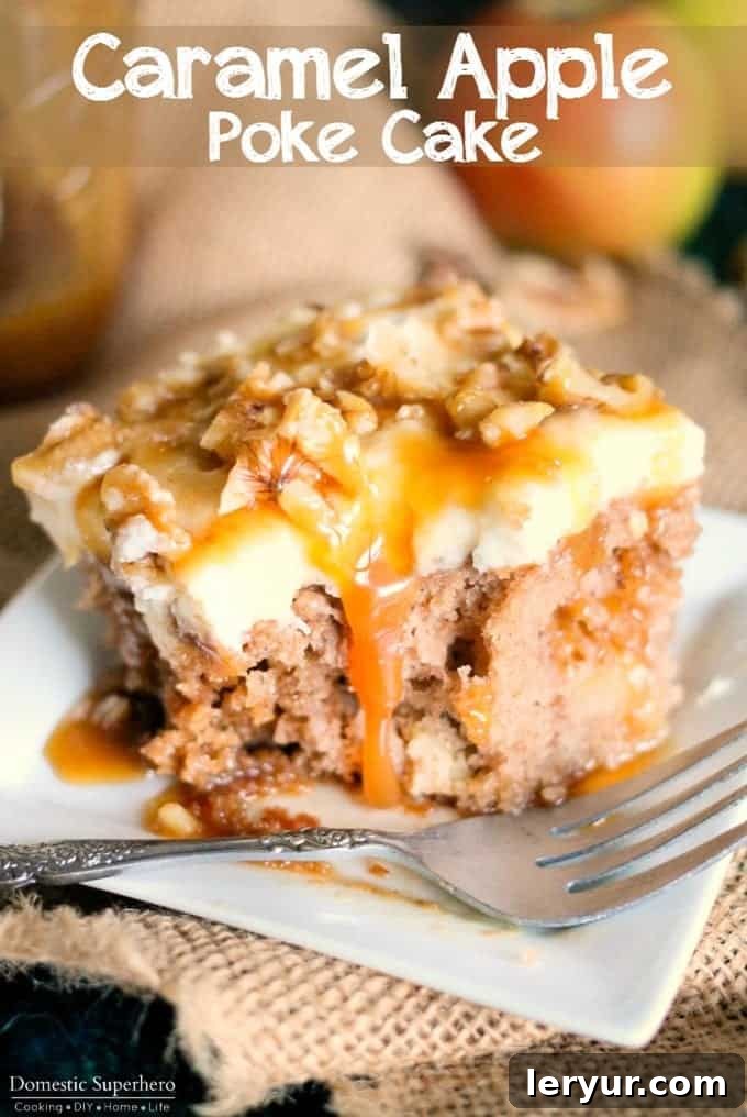 A slice of Caramel Apple Poke Cake, showing the caramel sauce seeped into the cake.