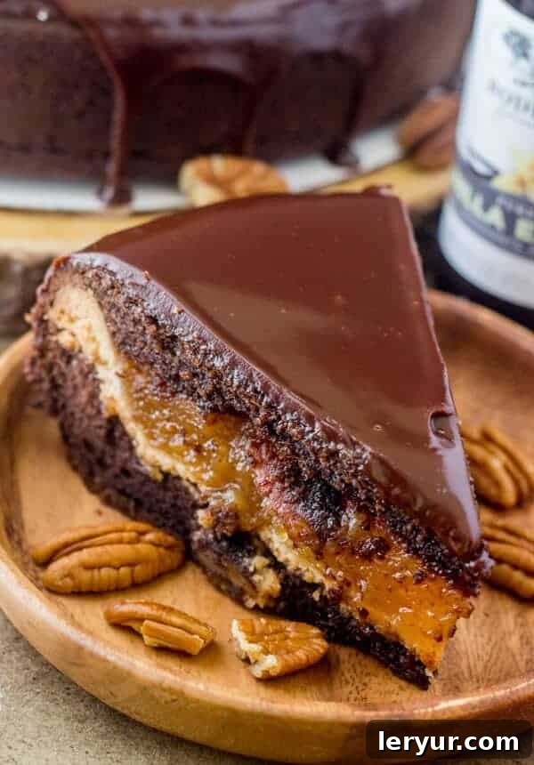 A slice of Chocolate Pecan Piecaken, revealing a layer of pecan pie baked inside a rich chocolate cake.