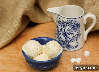 Dreamy Marshmallow Ice Cream 2 Three generous scoops of homemade marshmallow ice cream, nestled perfectly in a vibrant blue ceramic bowl.