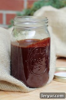 Dreamy Marshmallow Ice Cream 4 Rich, dark hot fudge sauce, homemade and shimmering, elegantly presented in a classic glass canning jar, perfect for topping any dessert.