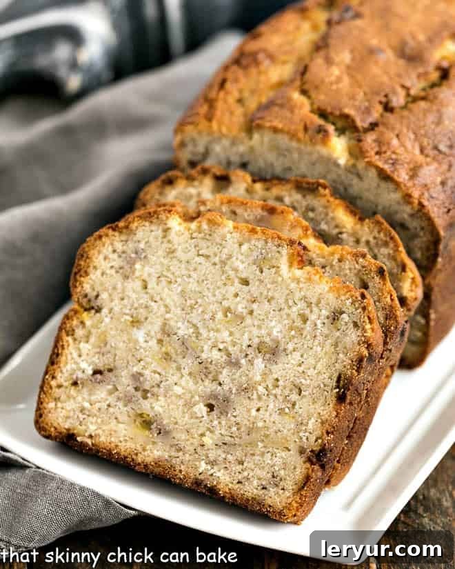 Buttermilk Banana Bread - sweet, tender, and dense banana loaf that's perfect for breakfast, brunch, or a satisfying snack! Slices of Buttermilk Banana Bread elegantly arranged on a pristine white ceramic tray, showcasing its tender crumb.