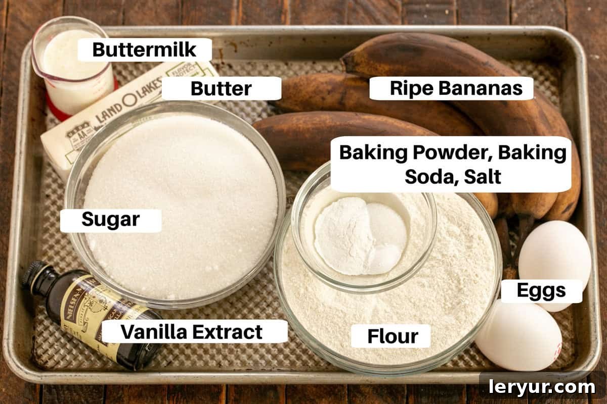 Velvety Buttermilk Banana Bread 2 Essential Buttermilk Banana Bread Ingredients meticulously laid out with labels on a sleek metal sheet pan.
