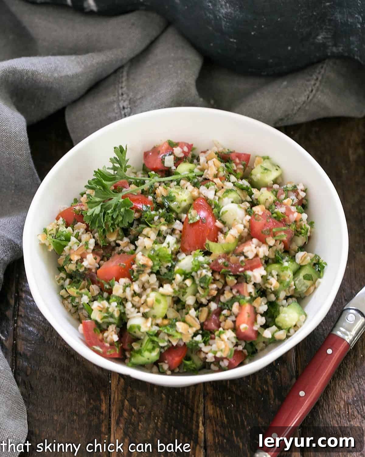 Mastering Classic Tabbouleh 4 A single serving of tabouli salad in a white bowl with a fork.