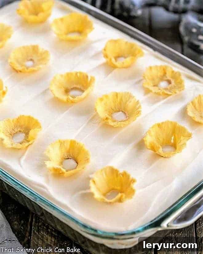 One layer carrot cake topped with cream cheese frosting and pineapple flowers