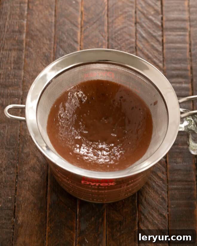 Whisking eggs and sugar, then slowly tempering with chocolate mixture.