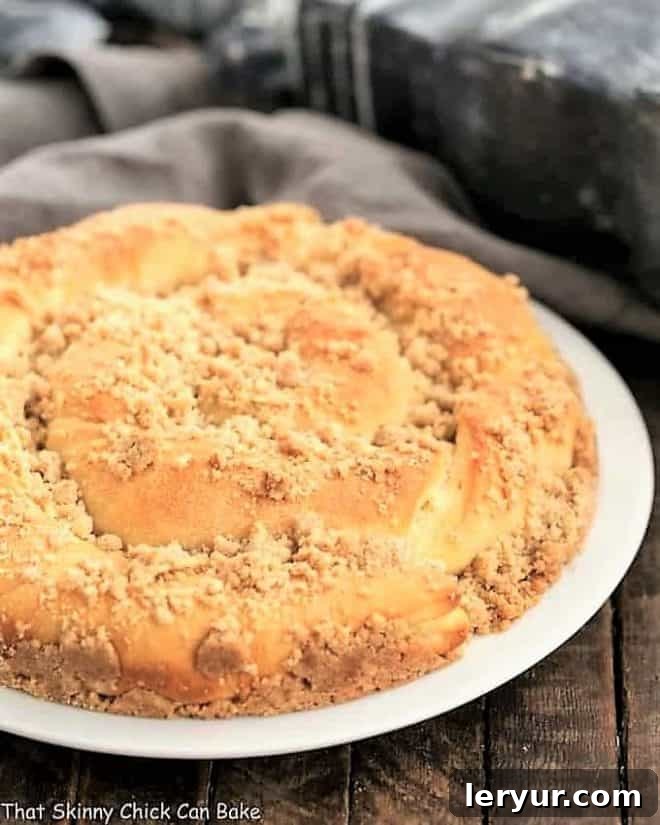 Copycat Sara Lee Coffee Cake - A cinnamon coffee cake recipe that's WAY better than the storebought version! Copycat Sara Lee Coffee Cake on a white serving plate
