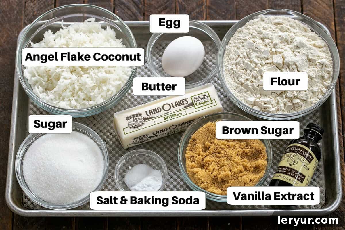 Perfectly Chewy Coconut Treats 3 All the essential ingredients for coconut cookies neatly arranged on a baking sheet, labeled for easy identification.