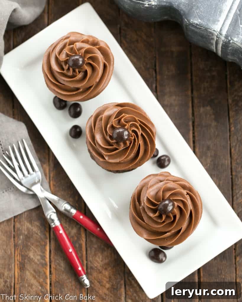 Frosted Chocolate Mocha Cupcakes - Moist, decadent chocolate cupcakes and creamy chocolate buttercream intensified with coffee! Overhead view of frosted chocolate mocha cupcakes arranged on a platter