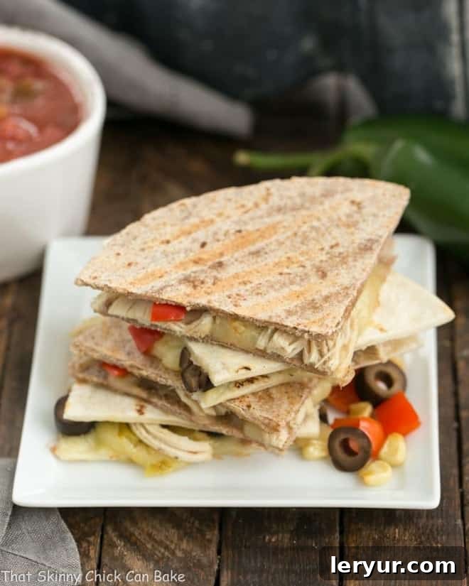 Spicy Chipotle Chicken Quesadillas 2 Cheesy Chipotle Chicken Quesadillas on square white plate.