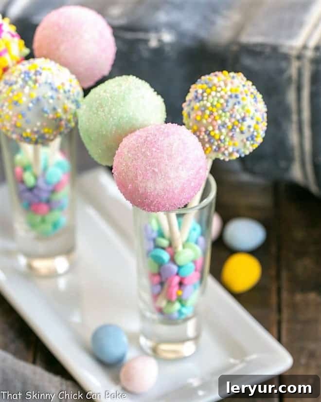 Easy and Festive Easter Cake Pops - Perfect for Spring Delightful Easter Cake Pops displayed in small shot glasses on a elegant porcelain tray.