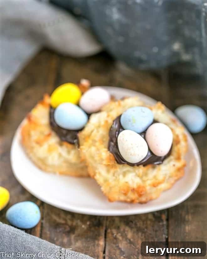 Two Coconut Macaroon Easter Nests on a small oval dish, showcasing the delicious filling and candy eggs