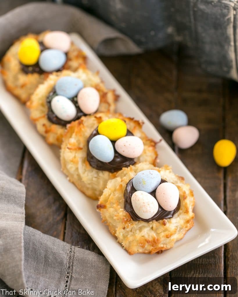 Coconut Macaroon Easter Nests lined up on a white ceramic tray, showcasing their perfectly formed nests