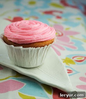 Array of baking ingredients for cupcakes and frosting, including flour, sugar, butter, and vanilla extract