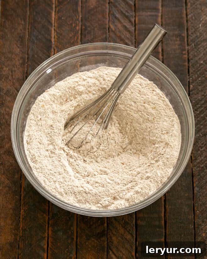 Effortless Traditional Irish Soda Bread 3 Dry ingredients for Irish Brown Bread in a bowl, being whisked together.