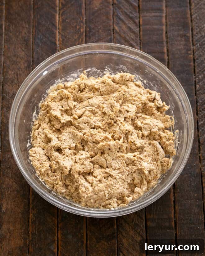 Effortless Traditional Irish Soda Bread 5 Buttermilk being stirred into the butter and dry ingredients mixture to form a soft dough.
