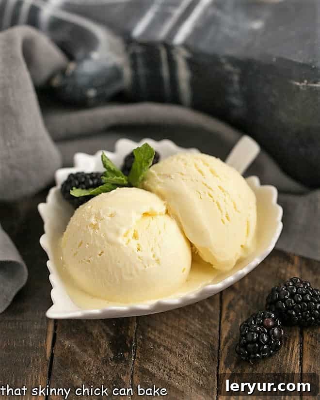 Two scoops of White Chocolate Ice Cream elegantly presented in a white leaf-shaped bowl.