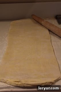 Puff pastry for gruyere prosciutto pinwheels Puff pastry resting on the counter after its second turn, visibly smoother and more refined.