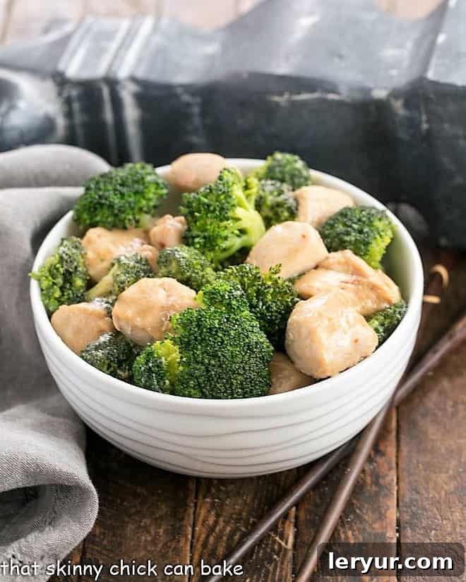 Chicken and Broccoli Stir Fry - A speedy, delicious meal with an Asian flair with homemade stir fry sauce. Make a better than take out dish at home! Broccoli chicken in a white bowl