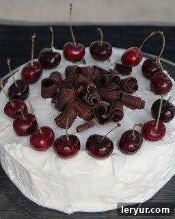 Whole Black Forest Cherry Cake, decorated with cream and cherries
