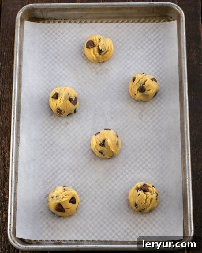 Step 4: Scooping out balls of cookie dough and placing them on a baking sheet.