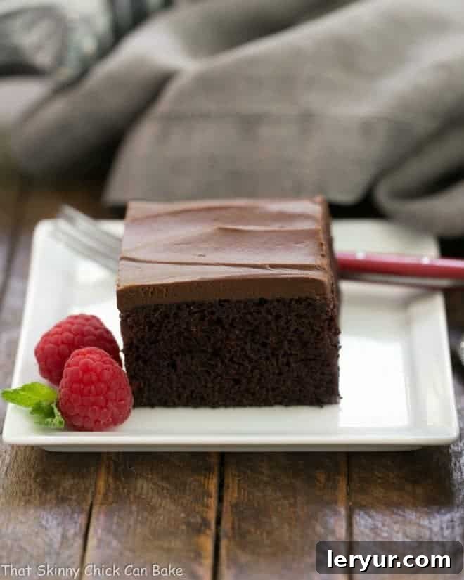 Velvet Night Snack Cakes 15 A beautifully frosted Black Magic Snack Cake, sliced and ready to be served, showcasing its rich chocolate flavor and moist texture.
