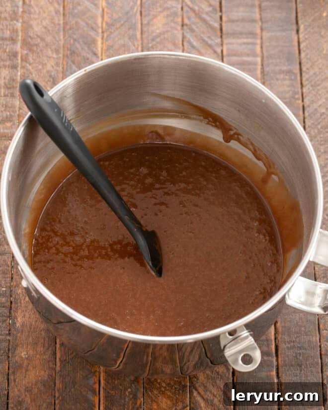 Velvet Night Snack Cakes 6 Dry and liquid ingredients for Black Magic Snack Cake blended together in a mixing bowl, showing a smooth, consistent batter.