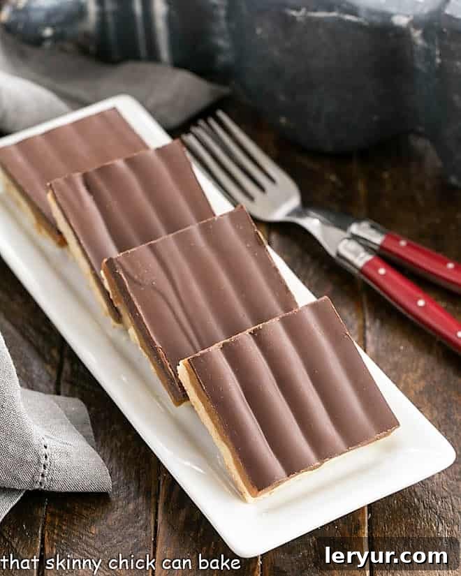 Homemade Twix Bars arranged on a white ceramic tray