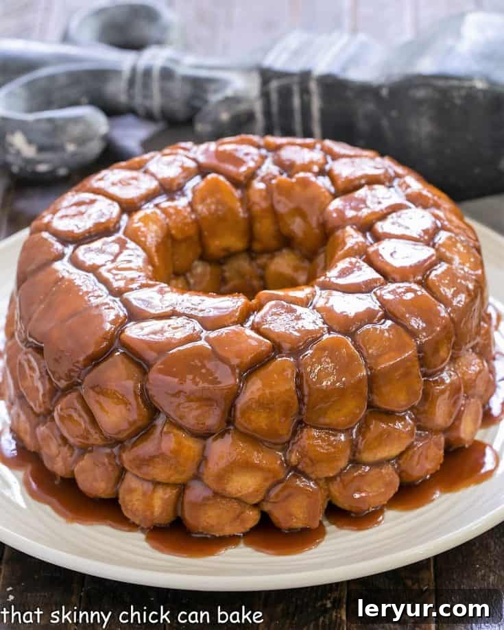 baked bubble bread on a white serving dish with melted butterscotch glaze