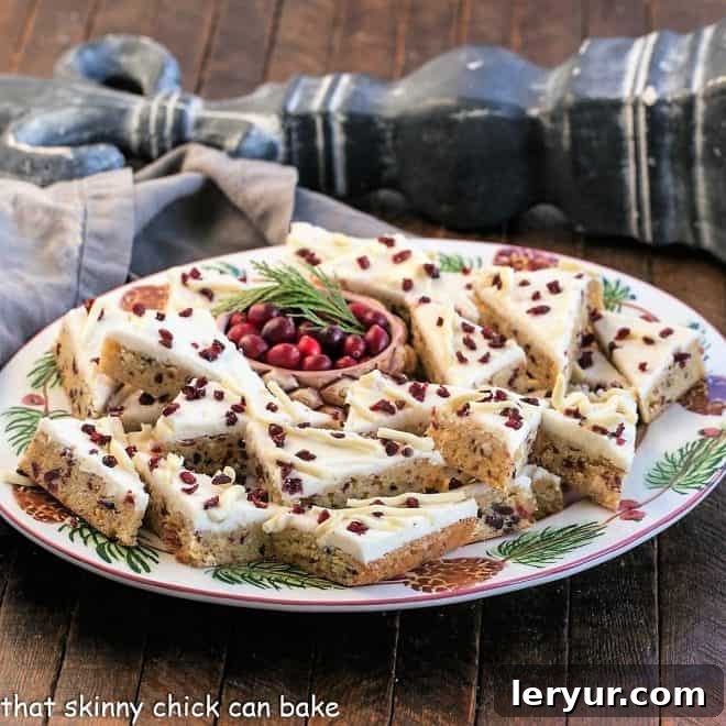 A festive oval tray of beautifully arranged copycat cranberry bliss bars, ready to be enjoyed during the holidays.