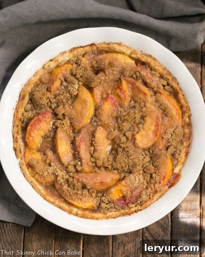 Easy Peach Crumb Pie, showcasing a delicious slice of pie with a rich crumb topping.