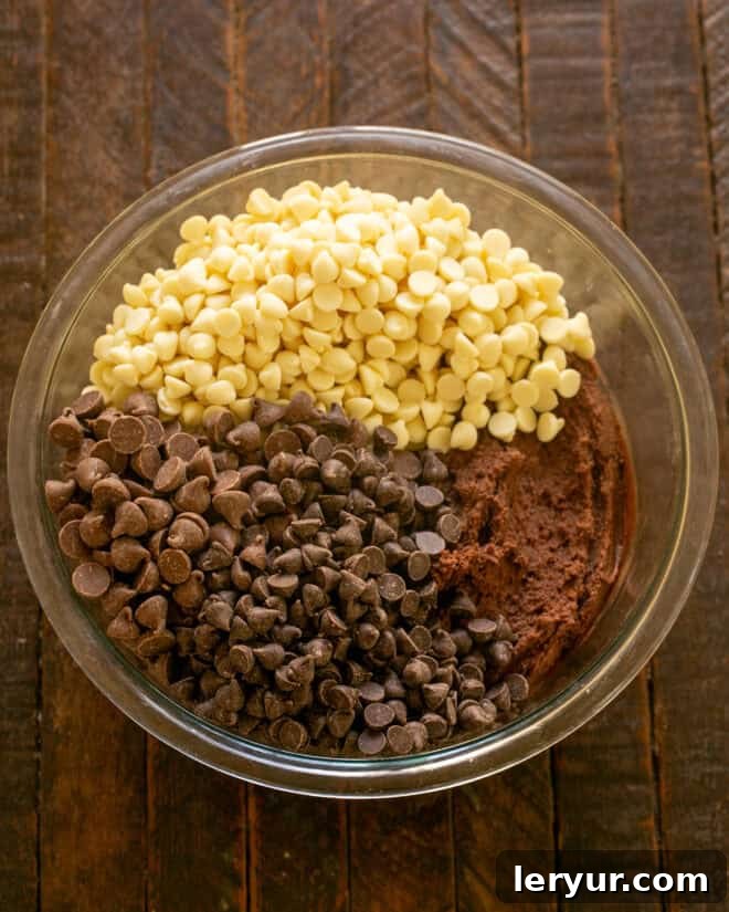 Step 4: Gently fold in the three varieties of chocolate chips (white, semi-sweet, and milk chocolate) by hand.