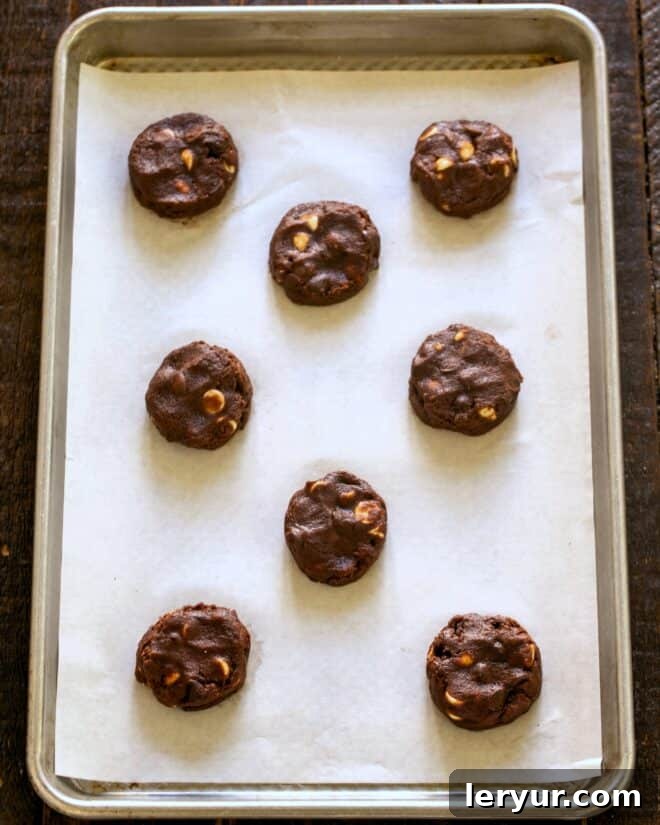 Step 5: Scoop uniform balls of quadruple chocolate chip cookie dough onto a parchment-lined baking sheet.