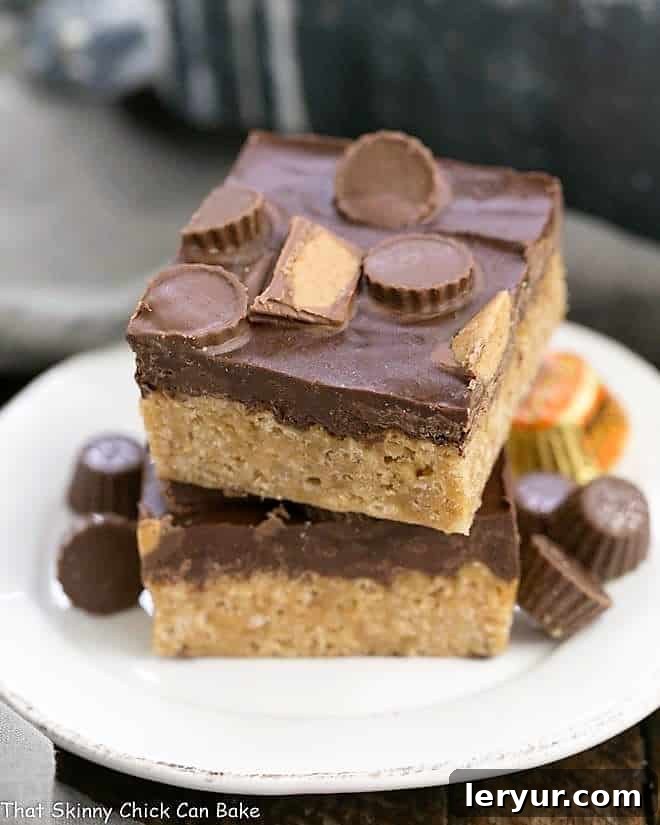 A stack of Reeses Rice Krispie Treats on a small white ceramic plate.