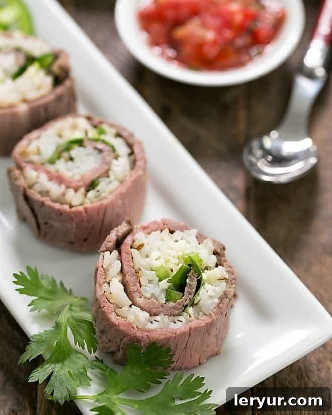 Deliciously arranged Texan Roll Beefshi slices on a pristine white narrow serving tray, showcasing their vibrant ingredients and inviting presentation.