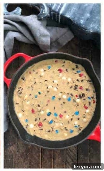 Spread the patriotic cookie dough evenly into the greased skillet.