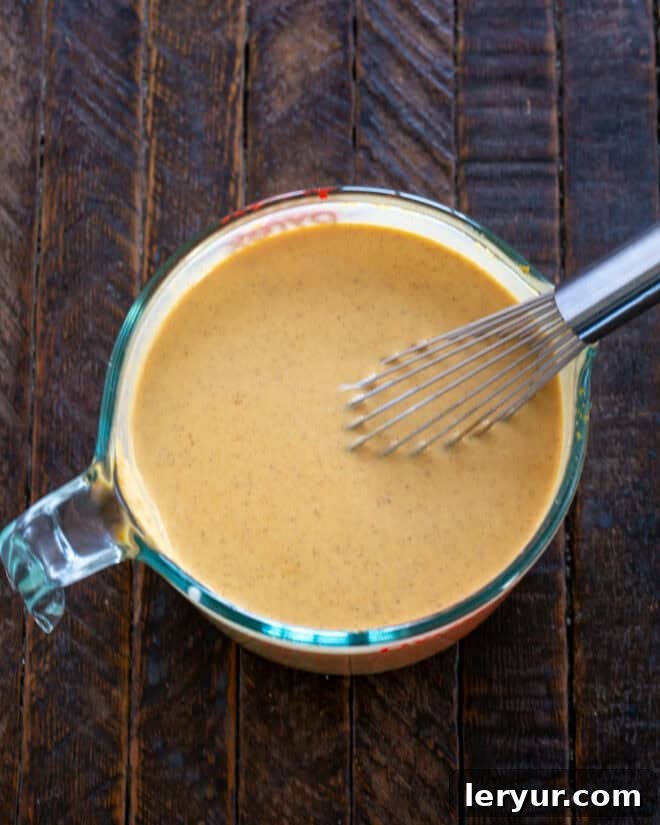 The Secret to Sublime Pumpkin Pie 5 Pouring heavy cream into the pumpkin mixture, the final step for a rich custard.