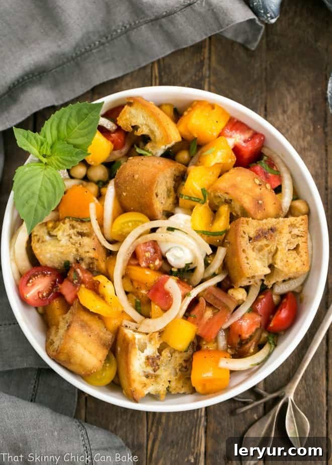 Sun-Drenched Tomato and Creamy Burrata Panzanella 2 Close-up of the delightful Summer Tomato and Burrata Panzanella Salad, highlighting the vibrant colors of tomatoes, the creamy burrata, and the golden-brown toasted bread cubes.